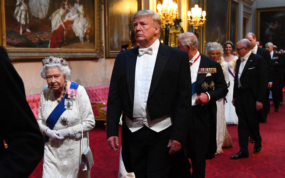 Queen Elizabeth II, US President Donald Trump and the Prince of Wales arrive through the East Gallery during the State Banquet at Buckingham Palace, London, on day one of the US President's three day state visit to the UK.