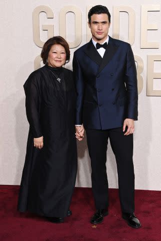 <p>Jon Kopaloff/WireImage</p> Charles Melton and his mom Sukyong Melton at the 2024 Golden Globes