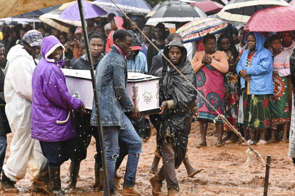 Pallbearers carry a coffin at the burial ceremony for some of the people who lost their lives following heavy rains caused by Cyclone Freddy in Blantyre, southern Malawi, Wednesday, March 15, 2023. (AP Photo/Thoko Chikondi)