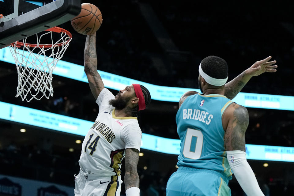 New Orleans Pelicans forward Brandon Ingram drives to the basket past Charlotte Hornets forward Miles Bridges during the first half of an NBA basketball game Friday, Dec. 15, 2023, in Charlotte, N.C. (AP Photo/Chris Carlson)