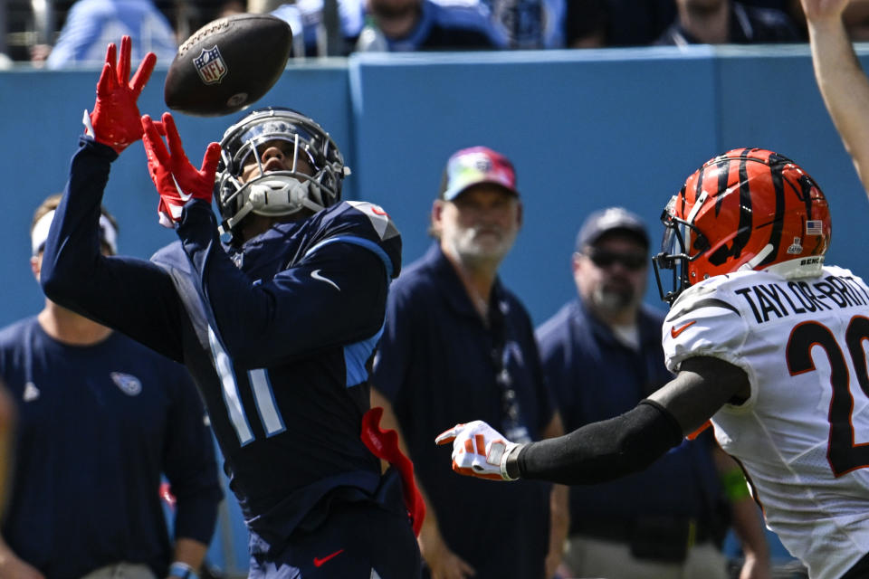 Tennessee Titans wide receiver Chris Moore (11) tries for a catch against Cincinnati Bengals cornerback Cam Taylor-Britt (29) during the first half of an NFL football game, Sunday, Oct. 1, 2023, in Nashville, Tenn. (AP Photo/John Amis)