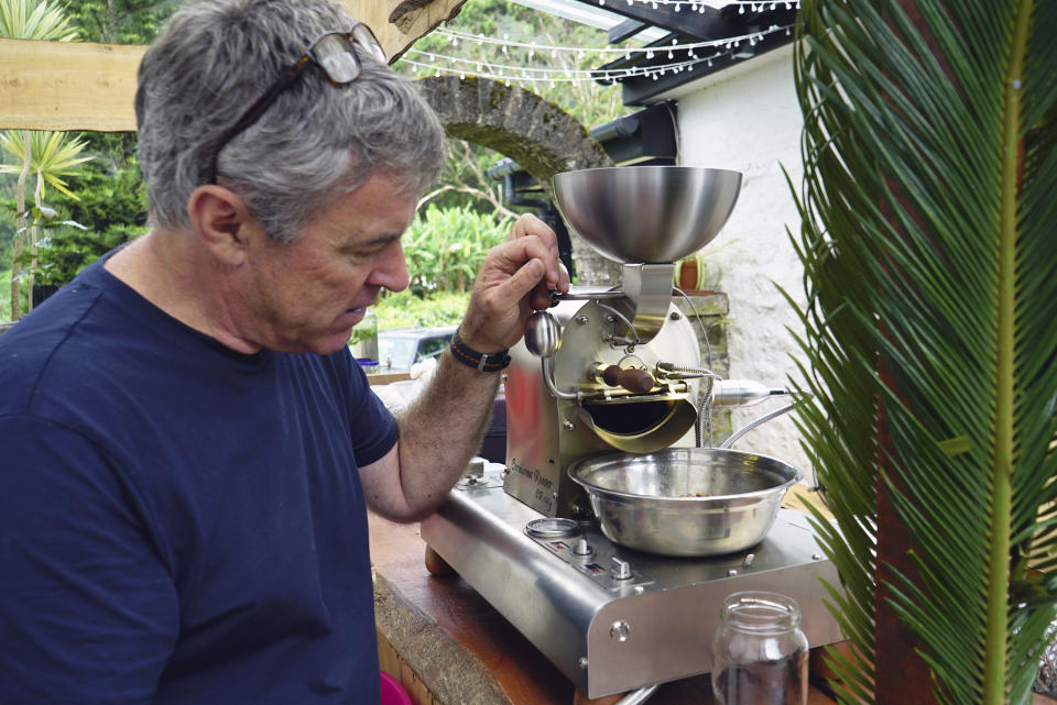 Neil Fantom of Wranghams coffee demonstrates his small-batch roasting process at his coffee plantation in Sandy Bay, St. Helena, Thursday, Feb. 22, 2024. (AP Photo/Nicole Evatt)