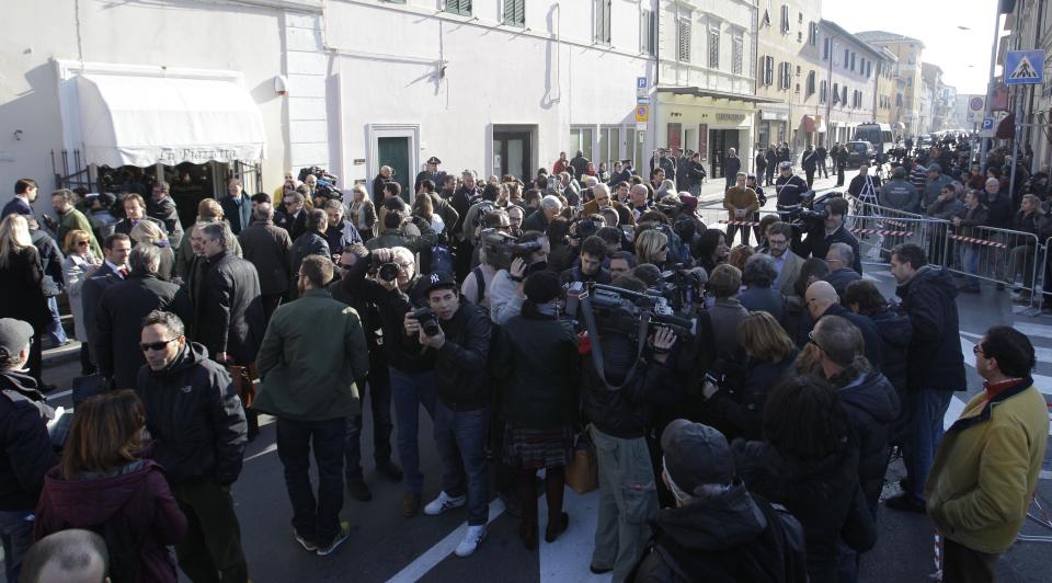 People gather outside the Moderno theater in Grosseto, Italy, Saturday, March 3, 2012 for the Costa Concordia shipwreck initial evidence hearing. The Italian prosecutor for the investigation of the Costa Concordia shipwreck says it could take experts three months to analyze the cruise ship's voice recorder. Prosecutor Francesco Verusio spoke to state radio as hundreds of lawyers, consultants, former passengers and crew arrived in Grosseto, Tuscany, Saturday for the initial evidence hearing. There are so many participants at the closed-door hearing that a local theater is being used. (AP Photo/Luca Bruno)