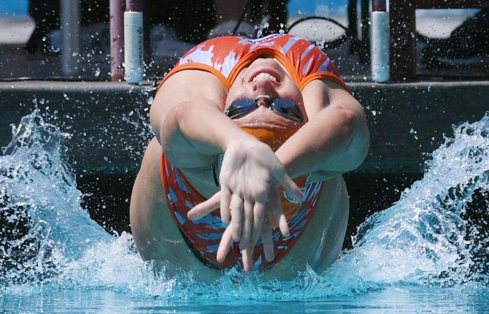Atascadero’s Annika Pauschek begins heat 4 of the Girls 100 Yard Backstroke Saturday, April 15, 2023 in Fresno. Clovis Unified’s Olympic Swim Complex at Clovis West opened this week after being closed almost a year for renovation and construction.