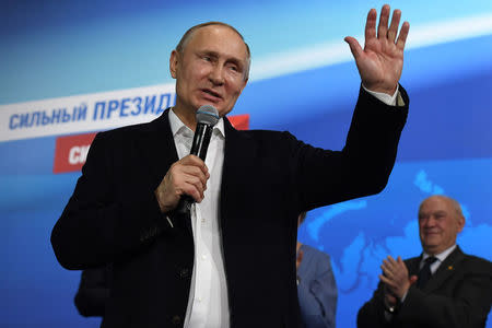 Russian President and Presidential candidate Vladimir Putin speaks during a meeting with supporters at his campaign headquarters in Moscow, Russia March 18, 2018. Yuri Kadobnov/POOL via Reuters