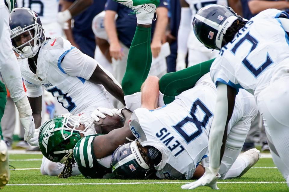 New York Jets linebacker Quincy Williams (56) recovers a ball fumbled by Tennessee Titans quarterback Will Levis (8) during the second quarter at Nissan Stadium in Nashville, Tenn., Sunday, Sept. 15, 2024.