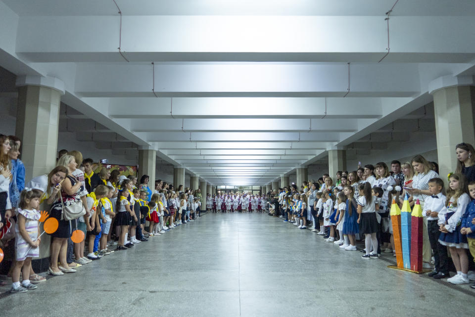 Schoolchildren attend a ceremony of the first day at school in a safe place in an underground subway station, in Kharkiv, Ukraine, Friday, Sept. 1, 2023. Ukraine marks Sept. 1 as Knowledge Day, as a traditional launch of the academic year. (AP Photo/Mstyslav Chernov)
