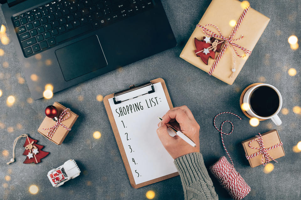 woman making a christmas shopping list