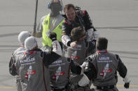 Cole Custer, top, celebrates with his crew after winning a NASCAR Cup Series auto race Sunday, July 12, 2020, in Sparta, Ky. (AP Photo/Mark Humphrey)