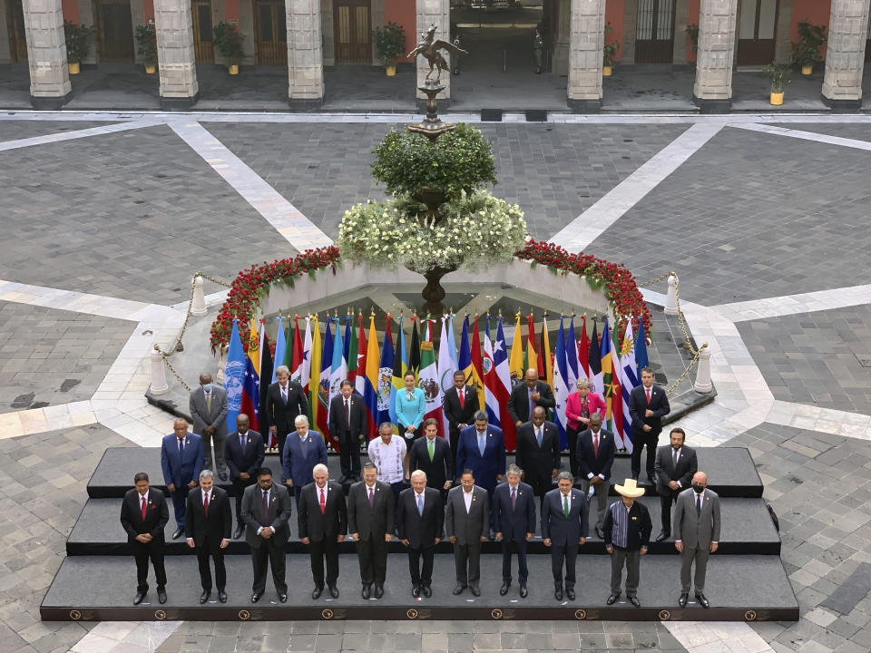 In this handout photo released by Mexico's Presidential Press Office, leaders from Latin America and the Caribbean pose for a group photo in a courtyard of the National Palace during the Community of Latin American and Caribbean States, or CELAC summit, in Mexico City, Saturday, Sept. 18, 2021. (Mexico's Presidential Press Office via AP)