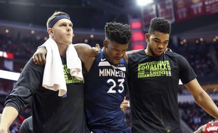 Feb 23, 2018; Houston, TX, USA; Minnesota Timberwolves guard Jimmy Butler (23) is helped off the court by teammates after an apparent injury during the third quarter against the Houston Rockets at Toyota Center. Mandatory Credit: Troy Taormina-USA TODAY Sports