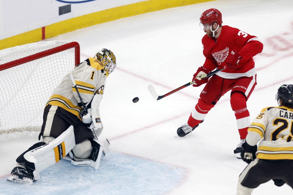 Detroit Red Wings' J.T. Compher (37) looks for the rebound off Boston Bruins' Jeremy Swayman (1) during the first period of an NHL hockey game Saturday, Oct. 28, 2023, in Boston. (AP Photo/Michael Dwyer)