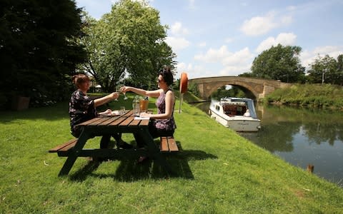 Two women enjoy lunch at a canalside pub in Oxfordshire - Credit: Clara Molden for The Telegraph