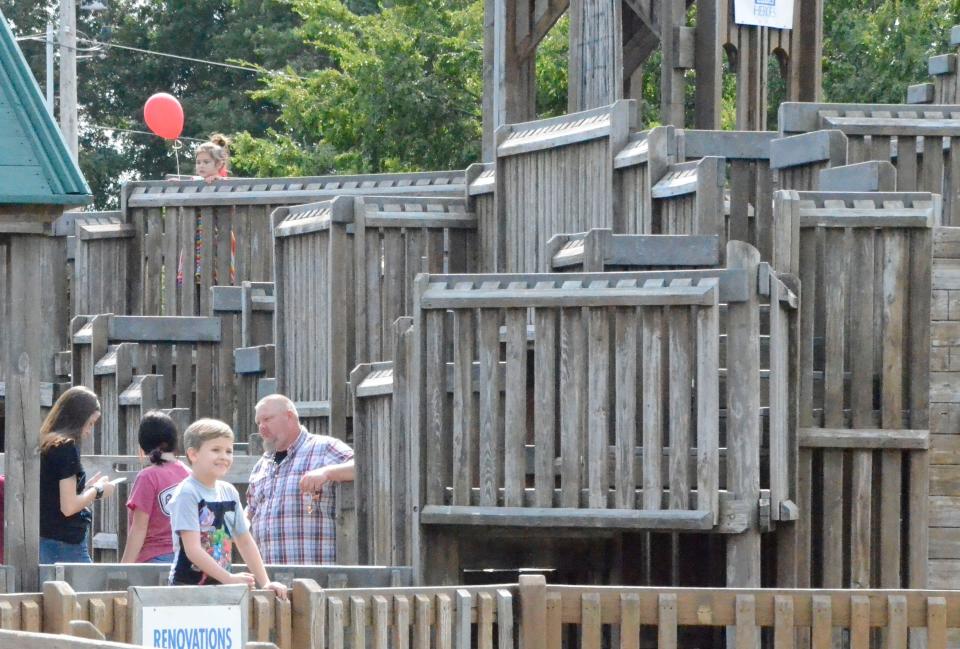 Residents enjoy the wooden structure called KidSpace. The aging, community-built park is coming down this week to make way for a new premiere park.