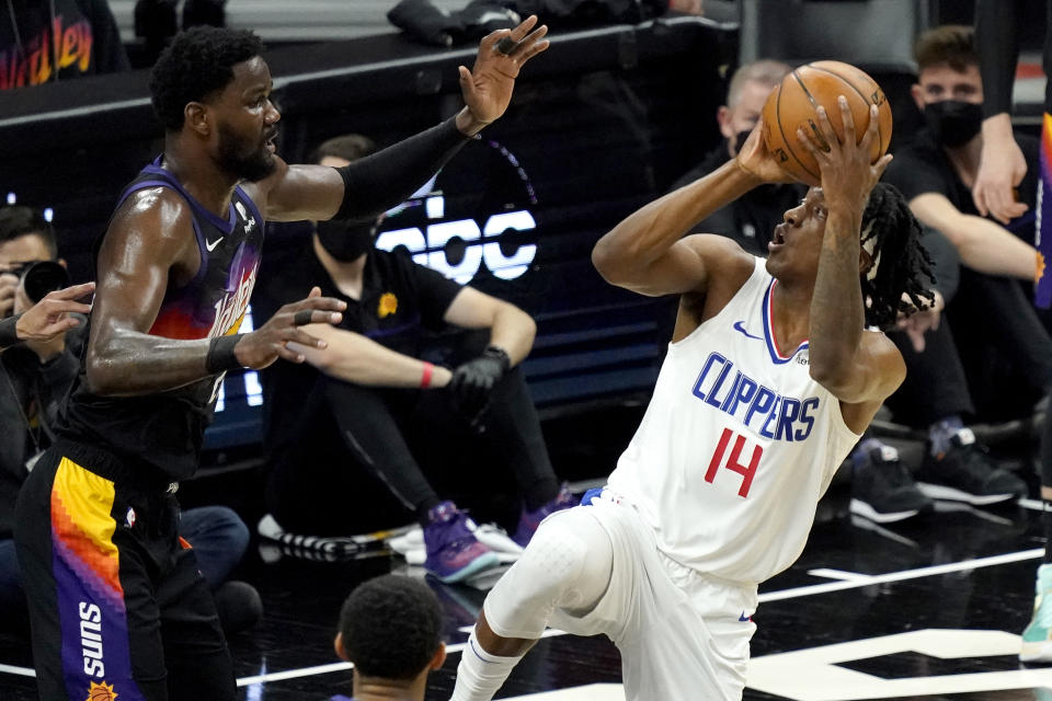 Los Angeles Clippers guard Terance Mann (14) shoots as Phoenix Suns center Deandre Ayton defends during the first half of game 5 of the NBA basketball Western Conference Finals, Monday, June 28, 2021, in Phoenix. (AP Photo/Matt York)