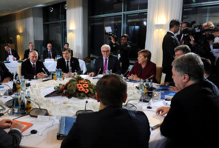 Russian President Vladimir Putin, German Foreign Minister Frank-Walter Steinmeier, German Chancellor Angela Merkel and Ukrainian President Petro Poroshenko attend talks on a stalled peace plan for eastern Ukraine at the Chancellery in Berlin, Germany, October 19, 2016. Sputnik/Kremlin/Mikhail Klimentyev via REUTERS