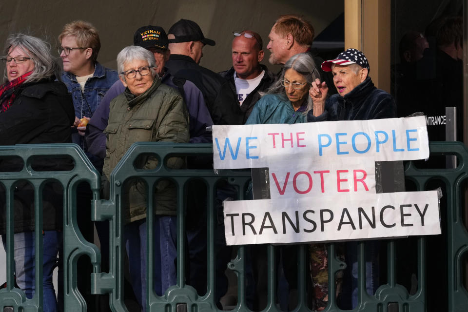 People wait to enter the Maricopa County Board of Supervisors auditorium prior to the board's general election canvass meeting, Monday, Nov. 28, 2022, in Phoenix. (AP Photo/Matt York)