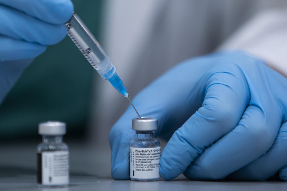 A health care professional prepares a Pfizer-BioNTech COVID-19 vaccine at Sheba Tel Hashomer Hospital in Ramat Gan, Israel, Tuesday, Jan. 12, 2021. Israel has struck a deal with Pfizer, promising to share vast troves of medical data with the drugmaker in exchange for the continued flow of its COVID-19 vaccine. Critics say the deal is raising major ethical concerns, including possible privacy violations and a deepening of the global divide between wealthy countries and poorer populations, including Palestinians in the occupied West Bank and Gaza, who face long waits to be inoculated. (AP Photo/Oded Balilty)