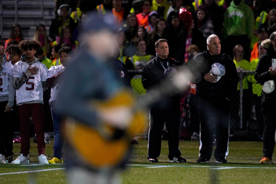 Singer James Taylor sings the national anthem as Edward Little High School players and first responders stand together, Wednesday, Nov. 1, 2023, prior to a high school football game in Lewiston, Maine. Locals seek a return to normalcy after a mass shooting on Oct. 25. (AP Photo/Matt York)