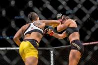 Jul 9, 2016; Las Vegas, NV, USA; Amanda Nunes (blue gloves) punches Miesha Tate (red gloves) during UFC 200 at T-Mobile Arena. Nunez won by rear naked choke. Mandatory Credit: Joshua Dahl-USA TODAY Sports