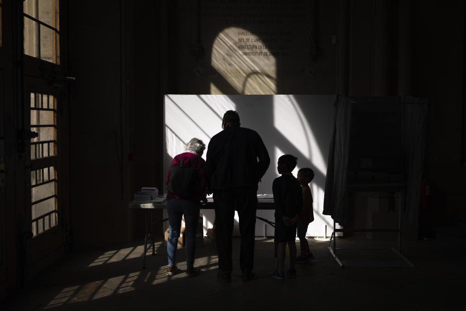 People select their ballots at a polling station during local elections in Barcelona, Spain, Sunday, May 28, 2023. Spain goes to the polls on Sunday for local and regional elections seen as a bellwether for a national vote in December, with the conservative Popular Party (PP) steadily gaining ground on the ruling Socialists in key regions. (AP Photo/Emilio Morenatti)