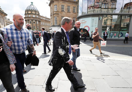 Brexit Party leader Nigel gestures after being hit with a milkshake while arriving for a Brexit Party campaign event in Newcastle, Britain, May 20, 2019. REUTERS/Scott Heppell