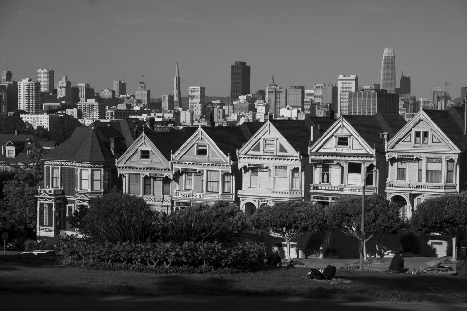 The "Painted Ladies" Victorian homes sit with the skyline in the background in San Francisco on May 7, 2020. Normally, the months leading into summer bring bustling crowds to the city's famous landmarks, but this year, because of the coronavirus threat they sit empty and quiet. Some parts are like eerie ghost towns or stark scenes from a science fiction movie. (AP Photo/Eric Risberg)