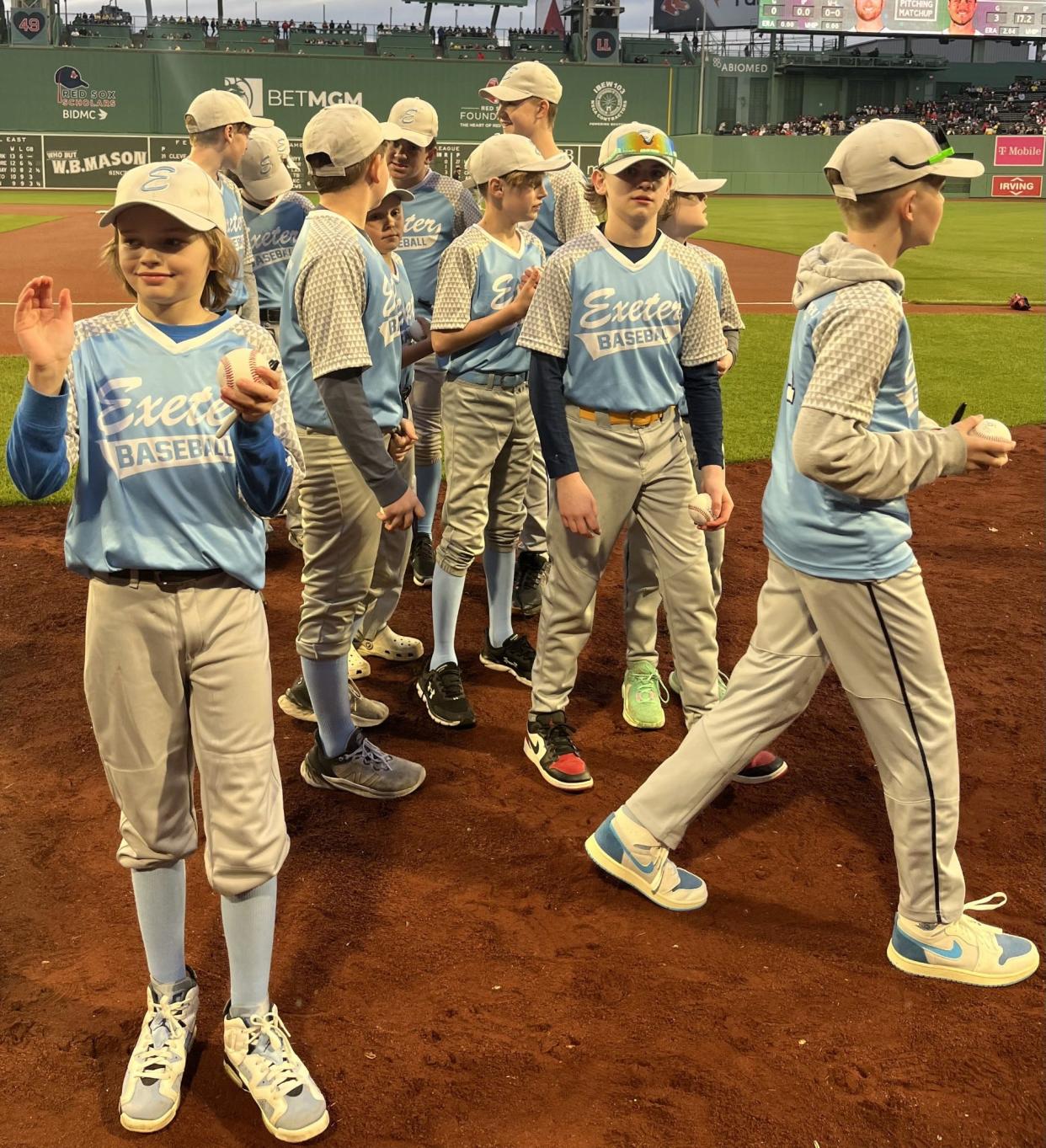 The Exeter Cal Ripken team of 12-and-under baseball players made an appearance on the field at Fenway Park in Boston, shaking hands with Red Sox players, Wednesday, April 17, 2024.