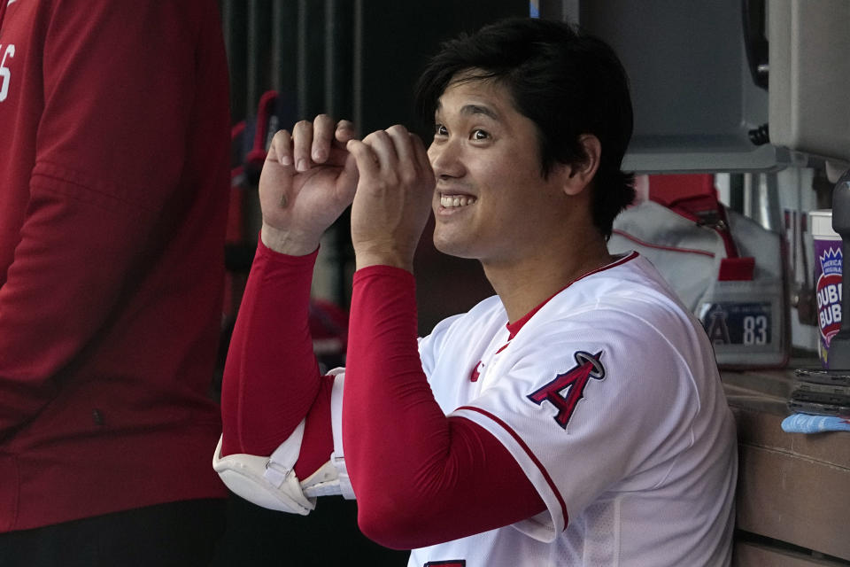 Los Angeles Angels' Shohei Ohtani gestures to a teammate during the first inning of a baseball game against the Chicago Cubs Thursday, June 8, 2023, in Anaheim, Calif. (AP Photo/Mark J. Terrill)