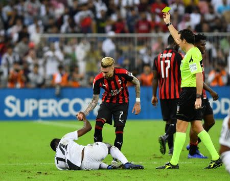 Soccer Football - Italian Super Cup - Juventus v AC Milan - King Abdullah Sports City, Jeddah, Saudi Arabia - January 16, 2019 AC Milan's Samu Castillejo is shown a yellow card by referee Luca Banti REUTERS/Waleed Ali