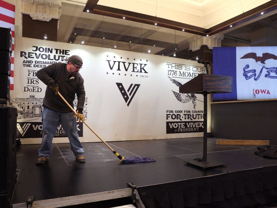 A worker mops the stage prior to Republican presidential candidate Vivek Ramaswamy's caucus night watch party on January 15, 2024 in Des Moines, Iowa.