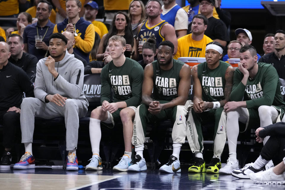 Milwaukee Bucks forward Giannis Antetokounmpo, left, watches from the bench with teammates during the second half against the Indiana Pacers in Game 6 in an NBA basketball first-round playoff series, Thursday, May 2, 2024, in Indianapolis. (AP Photo/Michael Conroy)