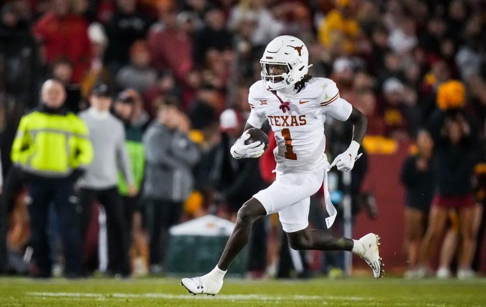 Texas wide receiver Xavier Worthy (1) carries the ball in the first half of the Longhorns' game against the Cyclones at Jack Trice Stadium in Ames, Iowa, Saturday, Nov. 18, 2023.