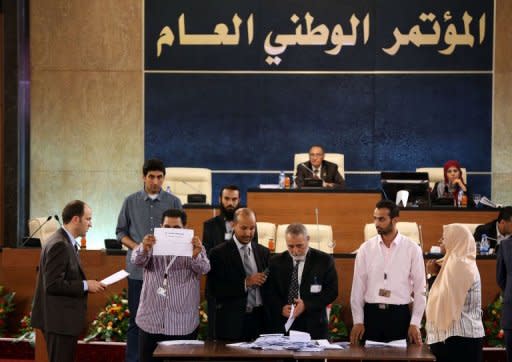 Members of the National assembly sort ballots as they choose their president in Tripoli on August 9, 2012. The new GNC president, Mohamed al-Megaryef, an economist with a British doctorate in finance, had held leading posts under the Kadhafi regime in the 1970s