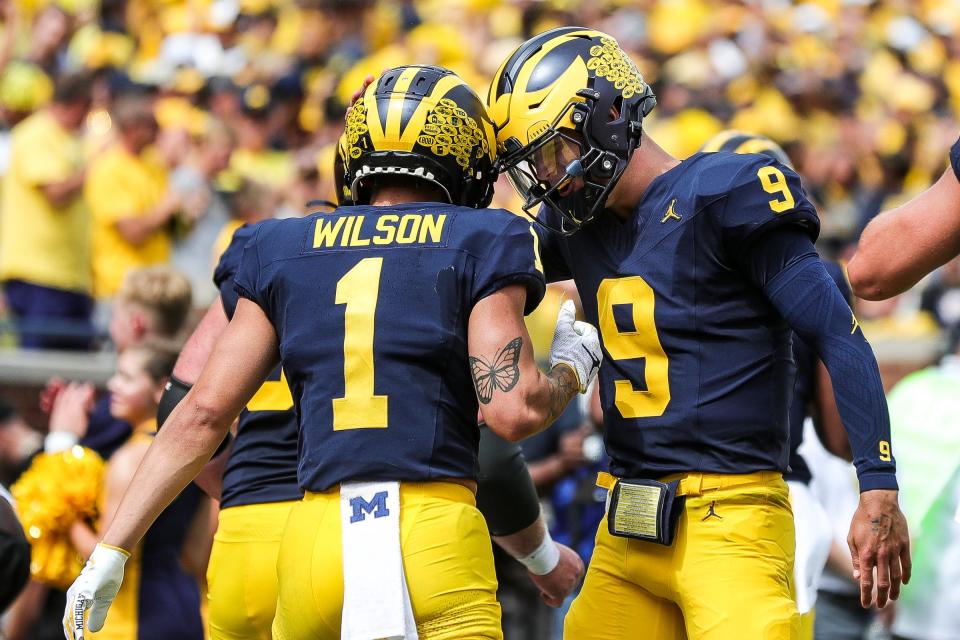 Michigan quarterback J.J. McCarthy celebrates a touchdown with wide receiver Roman Wilson against East Carolina during the second half of U-M's 30-3 win on Saturday, Sept. 2, 2023, at Michigan Stadium.