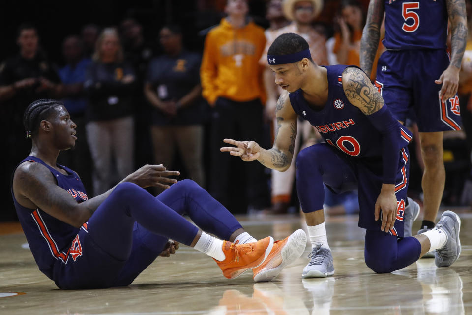 Auburn guard Samir Doughty (10) and forward Danjel Purifoy (3) react to a 3-point shot during an NCAA college basketball game against Tennessee, Saturday, March 7, 2020, in Knoxville, Tenn. Doughty made 8 of 13 3-pointers and finished with 32 points as No. 17 Auburn beat Tennessee 85-63 to snap a two-game skid in the regular-season finale. (AP Photo/Wade Payne)