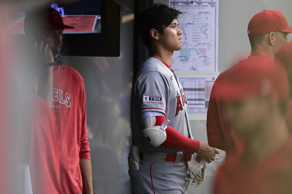 Los Angeles Angels' Shohei Ohtani stands in the dugout during the seventh inning of the team's baseball game against the Cleveland Guardians, Saturday, May 13, 2023, in Cleveland. (AP Photo/David Dermer)