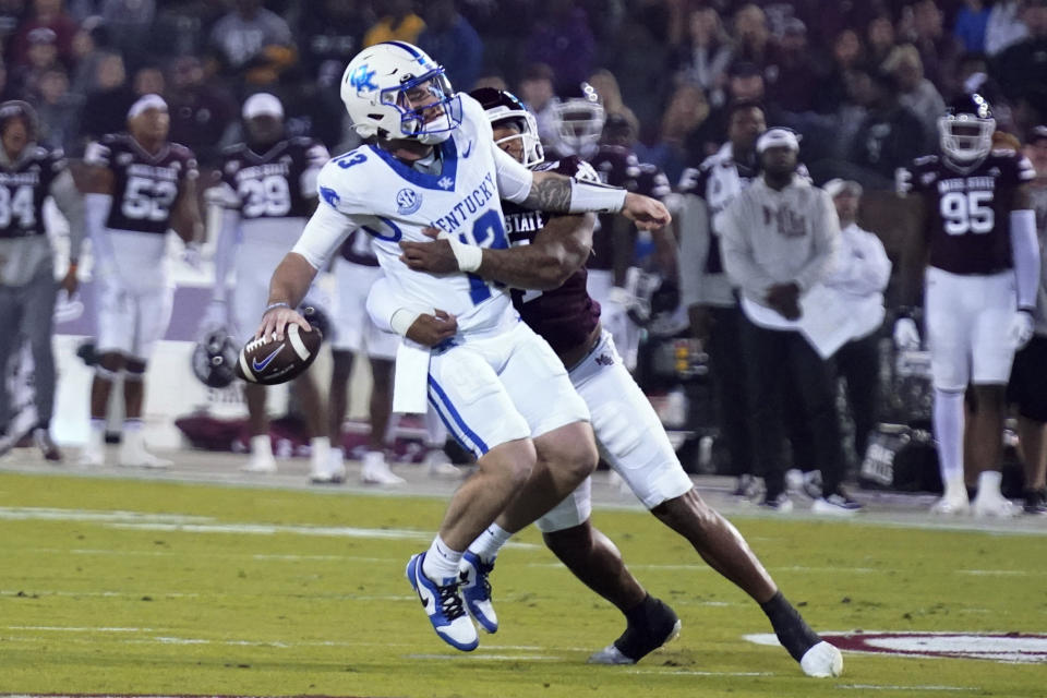 Kentucky quarterback Devin Leary (13) is sacked by Mississippi State linebacker Nathaniel Watson (14) during the first half of an NCAA college football game in Starkville, Miss., Saturday, Nov. 4, 2023. (AP Photo/Rogelio V. Solis)