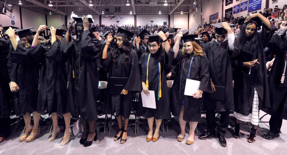 McMurry University students switch their tassels to hang on the opposite side of their mortarboard caps May 2017. McMurry, like other higher ed institution, is focusing on how to see all students through to graduation.