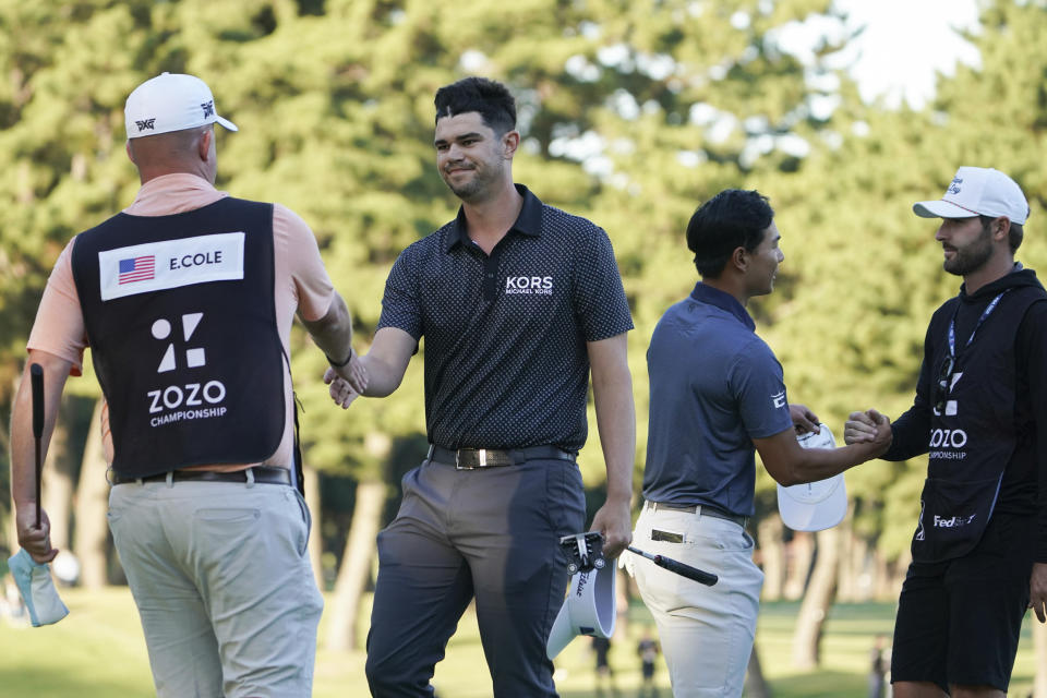 Beau Hossler of the United States, center left, and Justin Suh of the United States, center right, shake hands with caddies on the eighteenth green the PGA Tour Zozo Championship at the Narashino Country Club in Inzai on the outskirts of Tokyo, Sunday, Oct. 22, 2023. (AP Photo/Tomohiro Ohsumi)