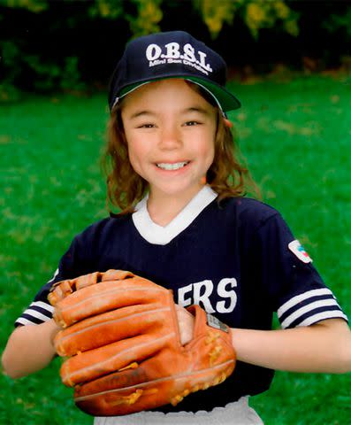 <p>Courtesy Nicole Shanahan</p> Despite having a challenging childhood, “I was a very optimistic kid,” says Nicole Shanahan (in her 1997 softball portrait).