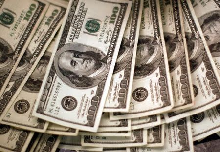 Four thousand U.S. dollars are counted out by a banker counting currency at a bank in Westminster, Colorado November 3, 2009. REUTERS/Rick Wilking/File Photo