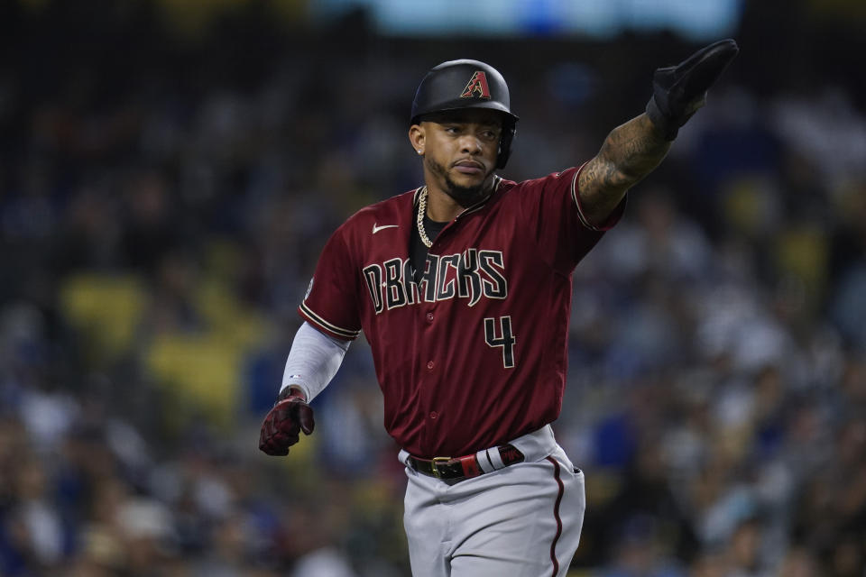 Arizona Diamondbacks' Ketel Marte points to Henry Ramos after scoring off of a single hit by Ramos during the fourth inning of a baseball game against the Los Angeles Dodgers Wednesday, Sept. 15, 2021, in Los Angeles. (AP Photo/Ashley Landis)