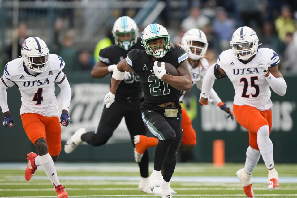 Tulane running back Makhi Hughes (21) ran for 166 yards in a win over UTSA in New Orleans, Friday, Nov. 24, 2023. (AP Photo/Gerald Herbert)