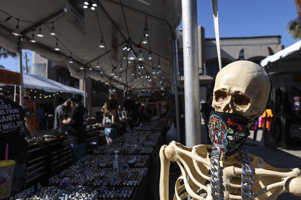 A plastic skeleton wearing a mask is set up outside of the Sanity Jewelers stand along Main Street in Daytona, FL during Bike Week on Friday, March 5, 2021. (Sam Thomas/Orlando Sentinel)