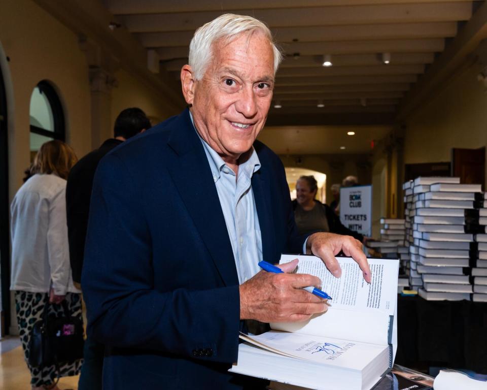 Walter Isaacson signs copies of "Elon Musk."