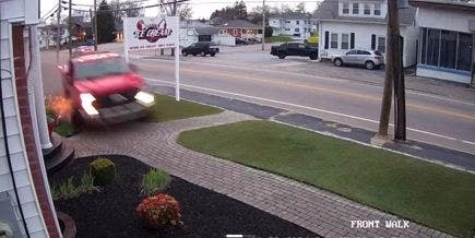 Truck speeding in front of ice cream parlor
