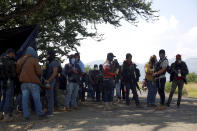 Members of the so-called self-defense group known as United Towns or Pueblos Unidos, gather for a rally in Nuevo Urecho, in the Mexican western state of Michoacan, Saturday Nov. 27, 2021. Extortion of avocado growers in western Mexico has gotten so bad that 500 vigilantes from the "self-defense" group gathered Saturday and pledged to aid police. (AP Photo/Armando Solis)