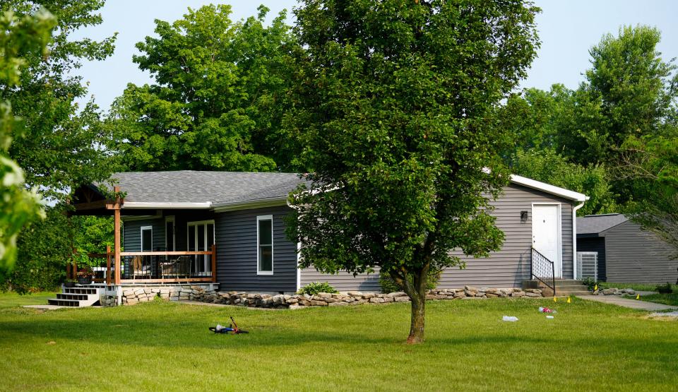 The home in Monroe Township where three boys, age 3, 4 and 7, were shot to death Thursday. Evidence markers can be seen at right.