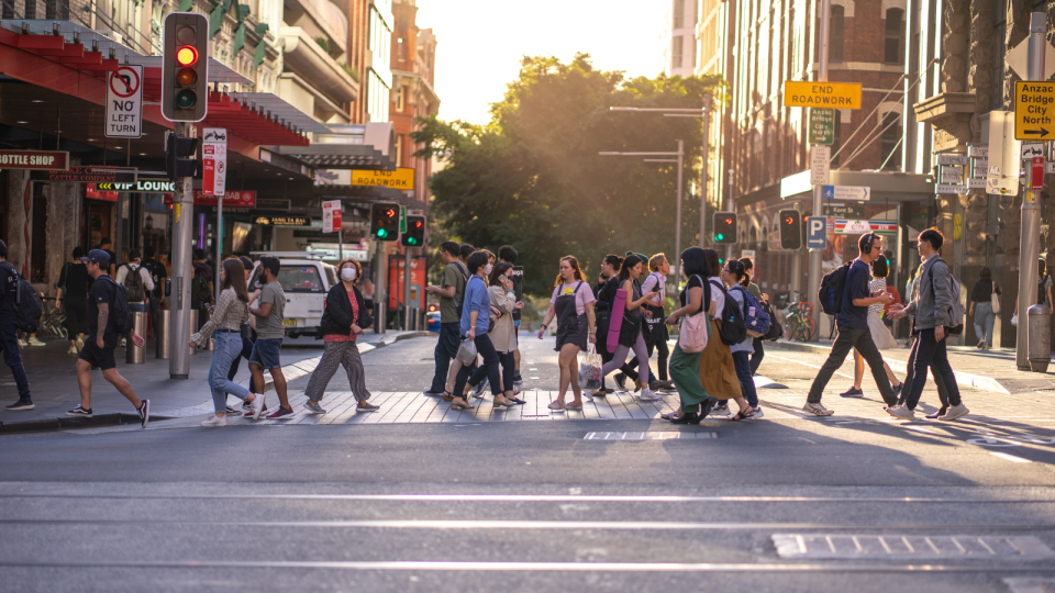 Jobs: People cross of busy street in the Sydney CBD